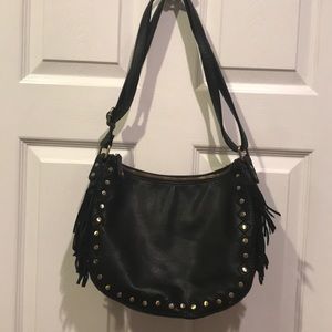 Black leather purse with fringe on sides.